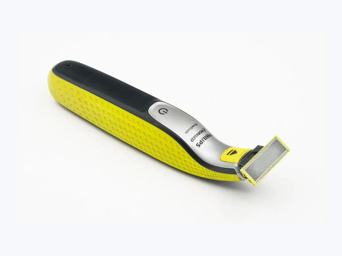 Yellow and black Philips OneBlade electric shaver and trimmer on a plain white background