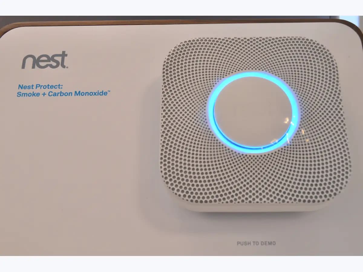 Google Nest Protect smoke and carbon monoxide alarm with its light ring glowing blue