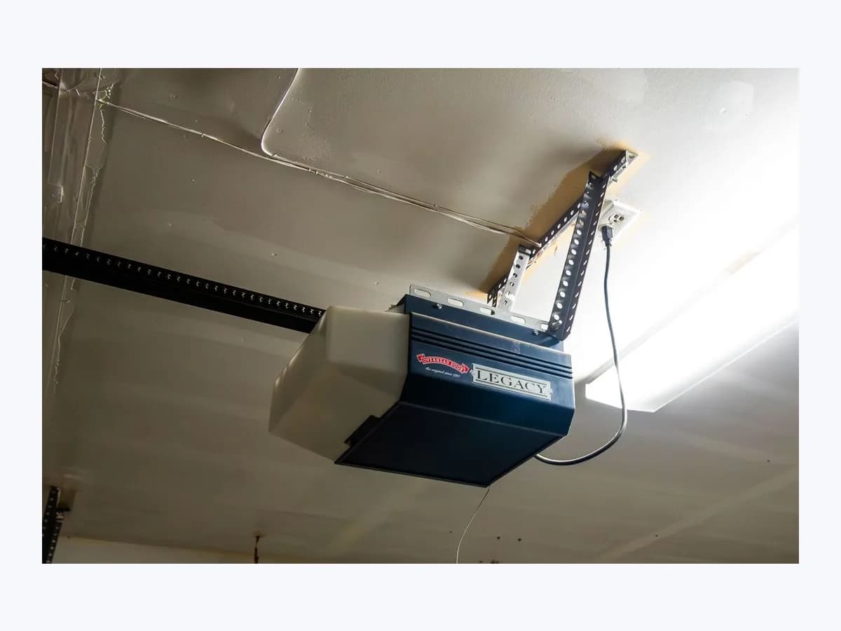 Ceiling-mounted Overhead Door Legacy garage door opener motor unit with chain-drive rail and mounting brackets